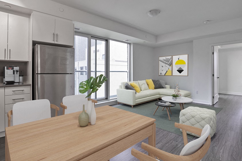 a living room and dining room with a table